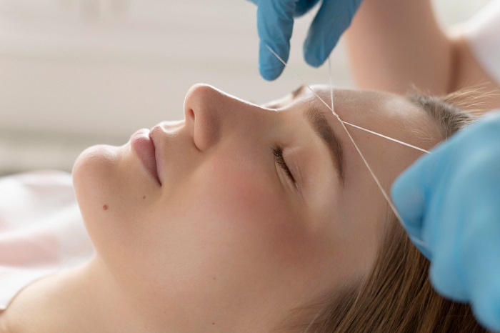 Threading in mega beauty salon megabeautyltd.co.uk a well equipped beauty salon close-up-young-woman-getting-eyebrow-treatment